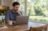 A homeowner at a kitchen table considering when to lock a mortgage rate.