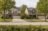 Two similar suburban Indiana homes side by side, illustrating that two loans can look alike and cost differently.