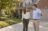 A real estate agent and a mortgage broker talking in the driveway of a Central Indiana home.